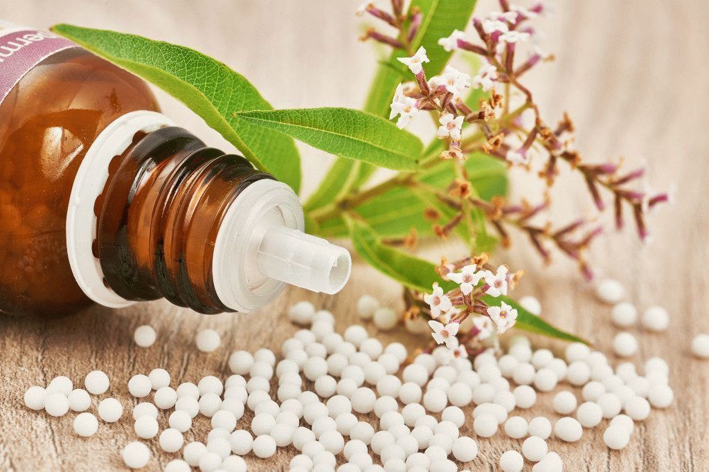 Homeopathic granules scattered on a wooden table